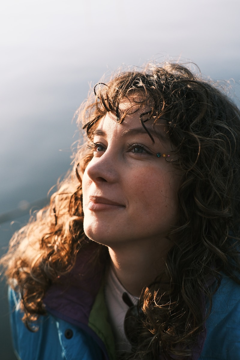 A close up of a person with curly hair